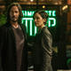 Neo and Trinity standing outside a coffee shop.